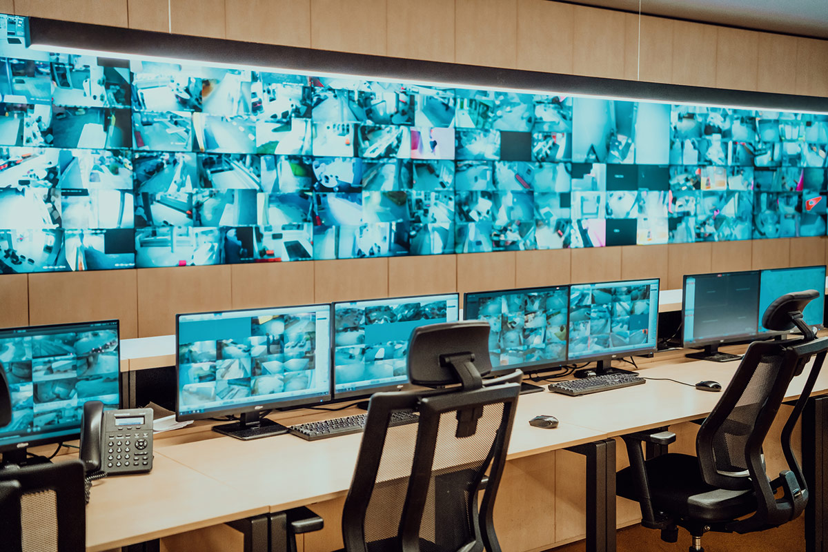 Empty interior of big modern security system control room, workstation with multiple displays
