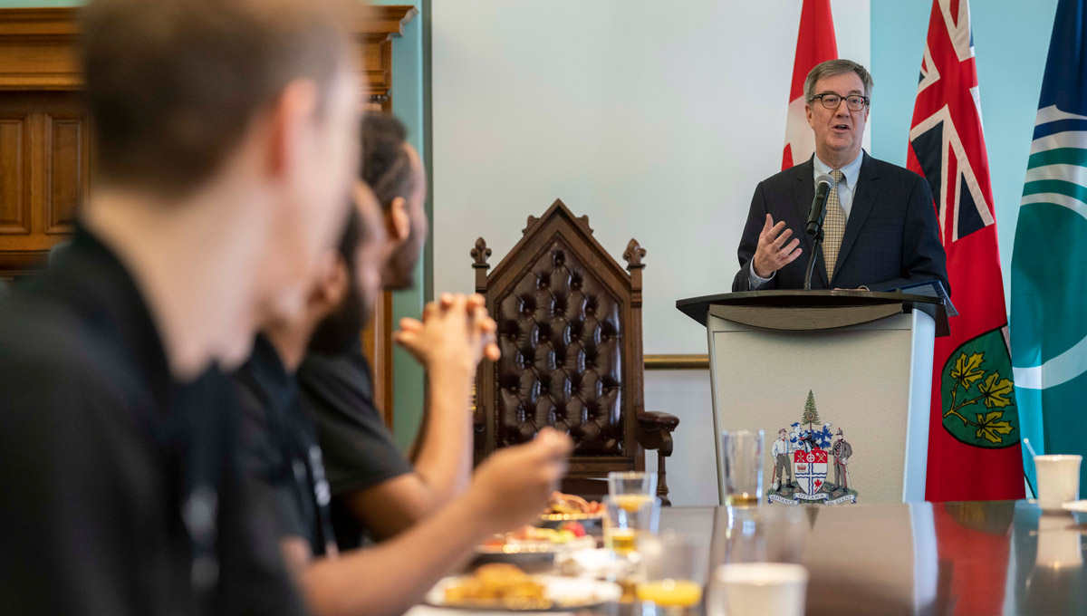 Mayor Jim Watson speaks during a celebration of Carleton Men's Basketball at City Hall for their 14th U Sports win in March 2019.