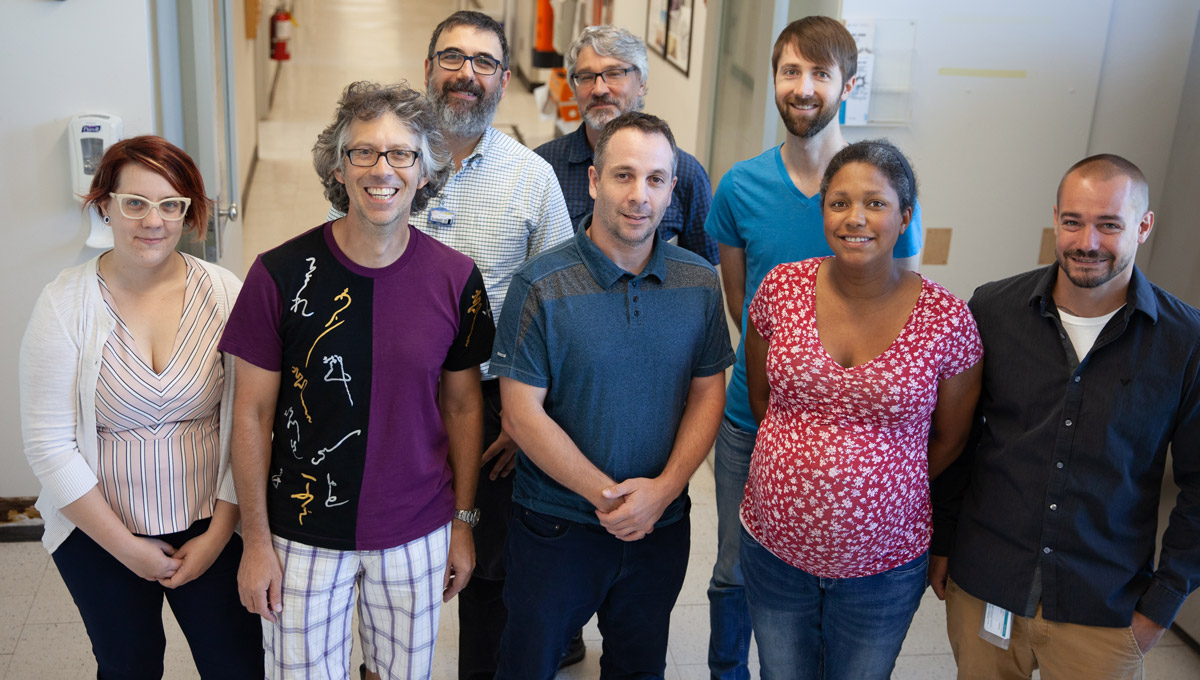 Members of the Ottawa Medical Physics Institute pose in a lab setting.