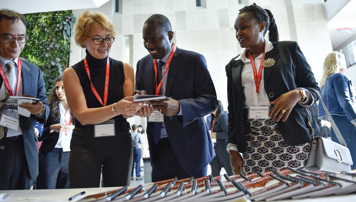 Diplomats connect and network as they gather printed programs during the annual Orientation for Newly Arrived Diplomats in September 2018.