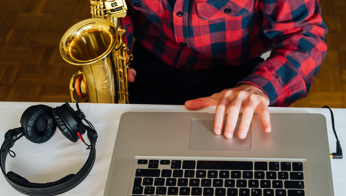 A saxaphone, laptop and headphones