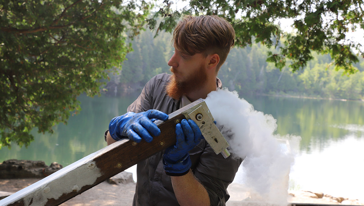 An Anthropocene research team member holds up a large piece of freeze core