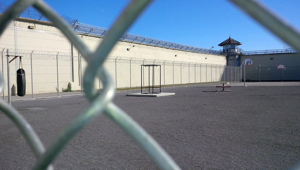 The view of a prison yard from outside the prison fence.
