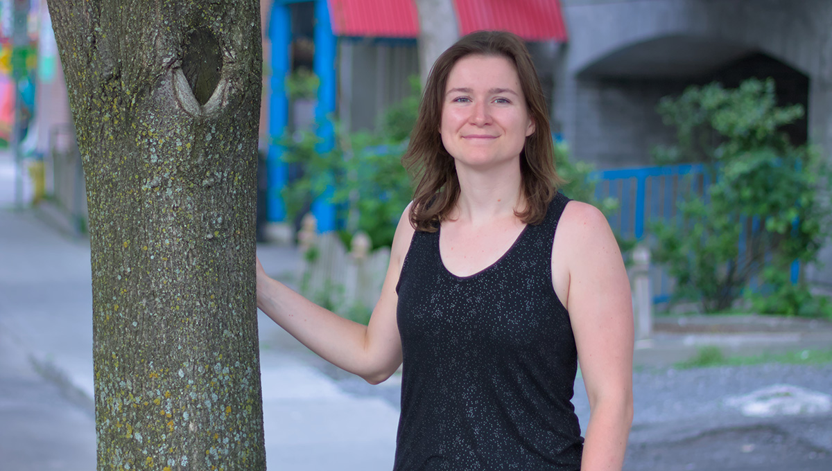 A photo of Emma Hudgins, a Post-Doctoral Research Fellow looking to minimize the threat of invasive insects in a changing climate