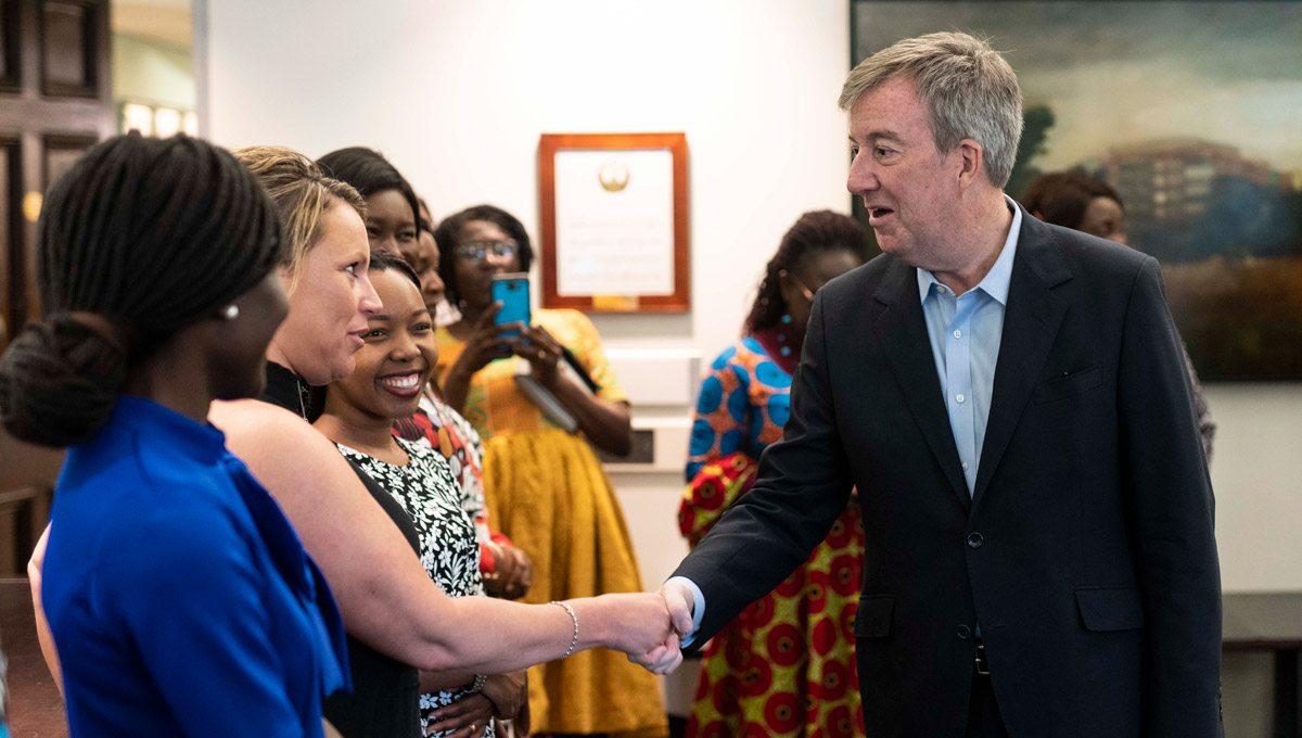 Mayor Jim Watson greets a Carleton PhD candidate at City Hall.