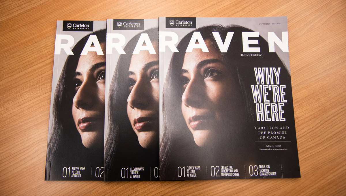 Three copies of the Raven Magazine spread out on a table.