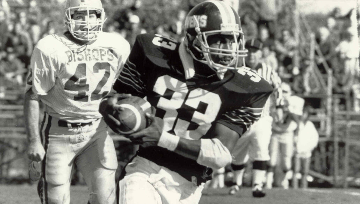 A black and white photo of a Carleton Raven rushing during a game.