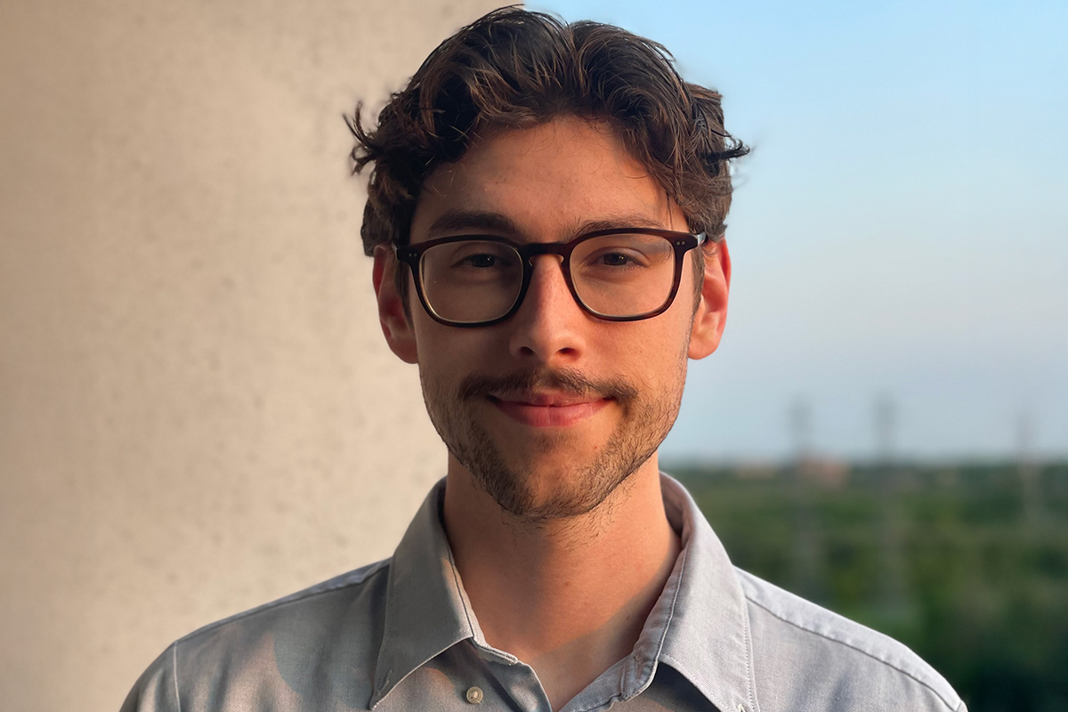 A head shot of a young man with glasses and short brown hair.