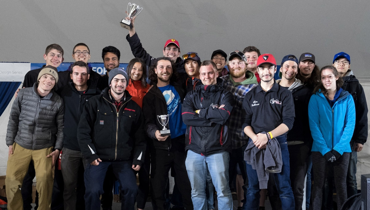 The Carleton University Ravens Racing team poses together with their trophy.