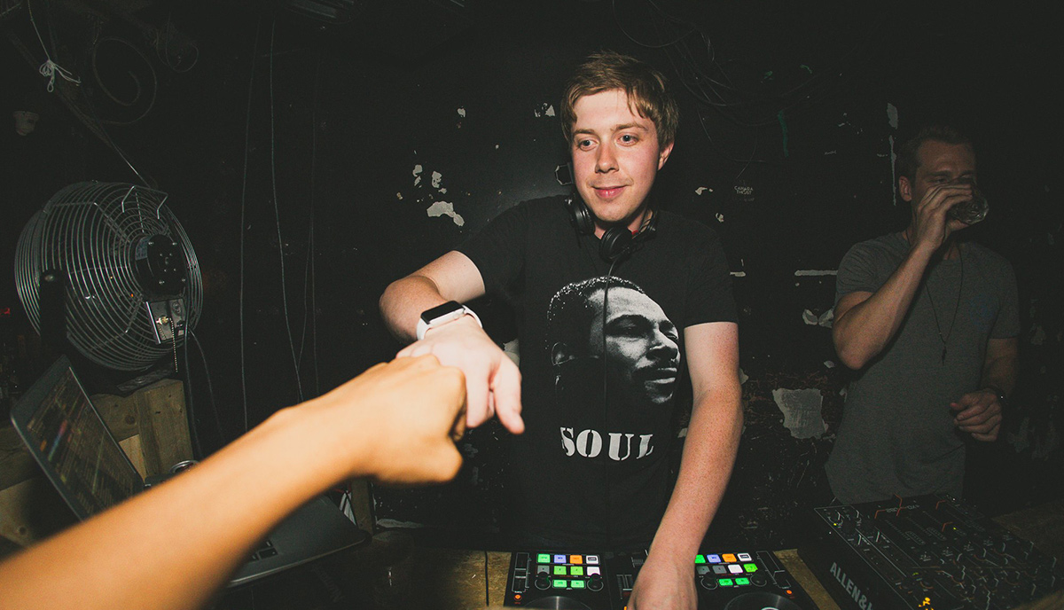 Photo of Nicholas Osborne working as a DJ in a nightclub