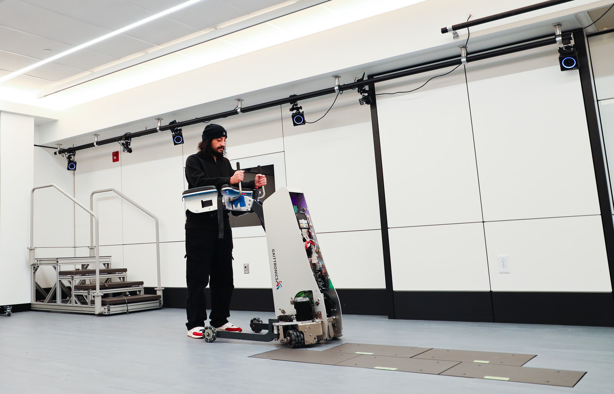 A researcher tests a design from the Rehabilitation Robotics Laboratory. 