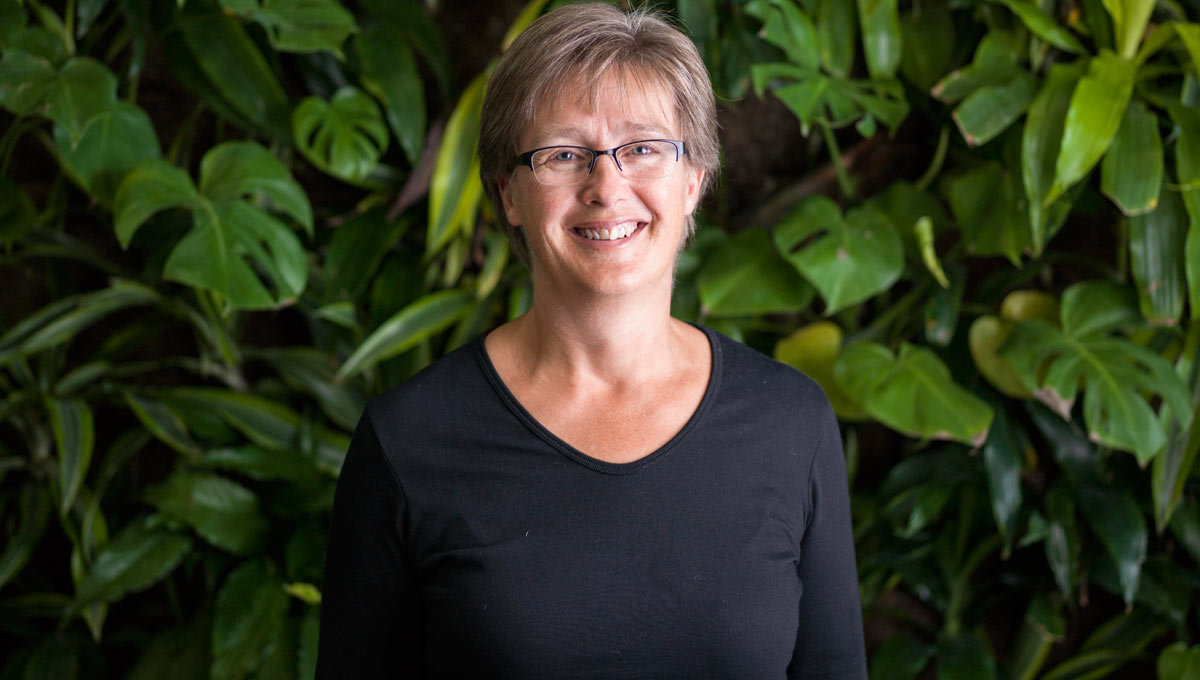 Prof. Lenore Fahrig poses against a plant-covered living wall in RIchcraft Hall.