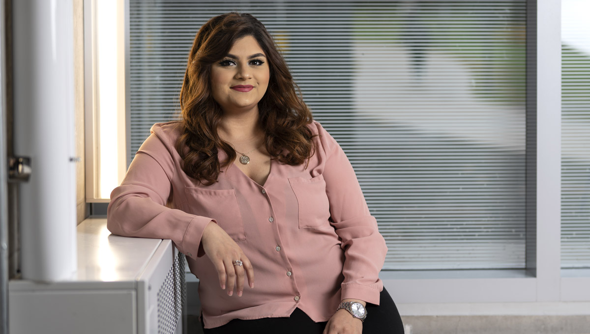 A headshot of Saira Gokal who is wearing a blouse and a wristwatch.