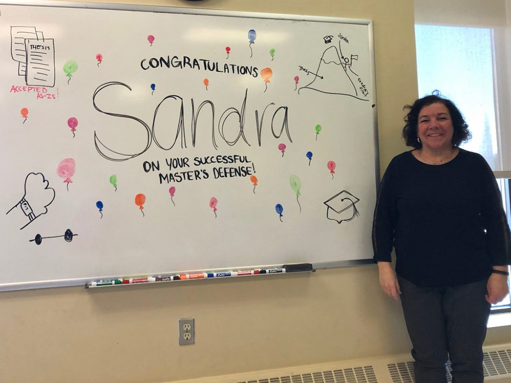 Sandra is congratulated after successfully defending her Master’s of HCI thesis (Photo: CHORUS)