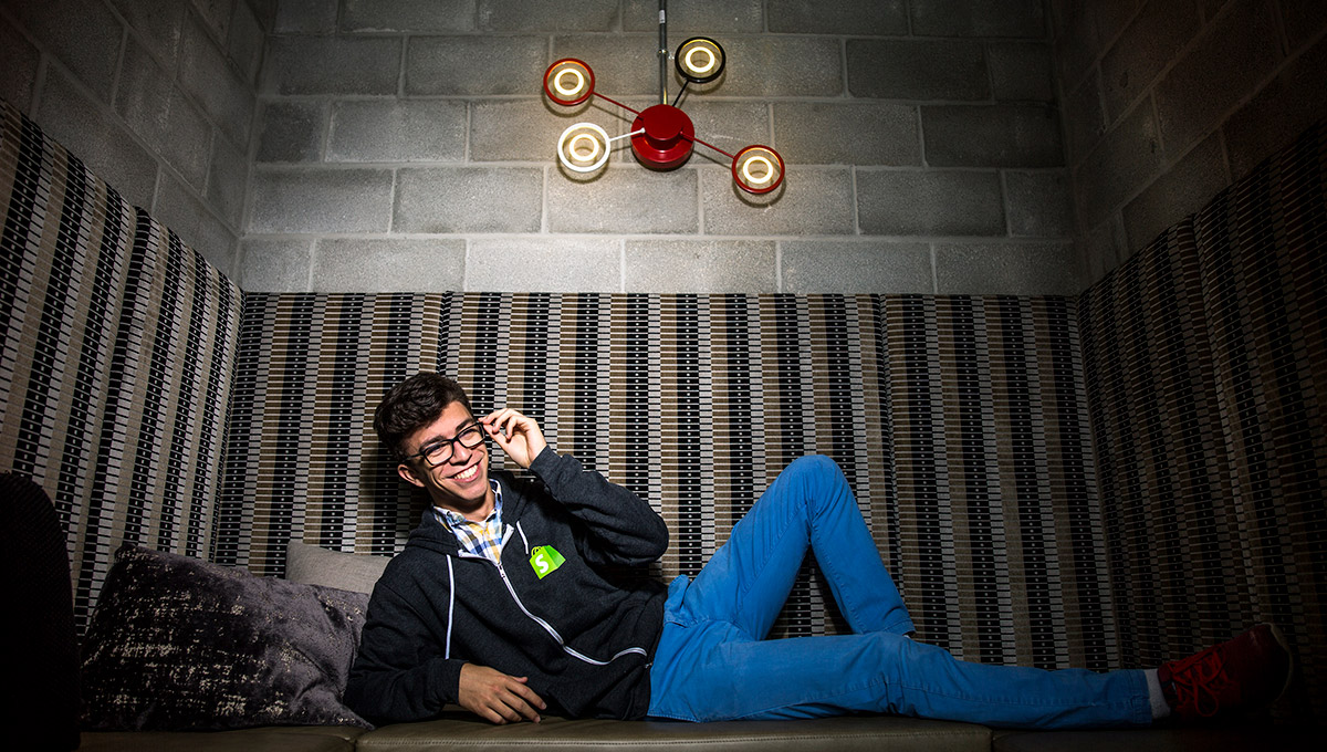 Niko Kouloufakos (pictured here), one of the students in Carleton's Dev Degree partnership with Shopify, splits his time between campus & the company’s headquarters, earning valuable career experience.