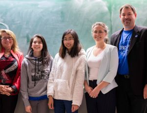 Carleton and Ottawa-area students pose together against a blackboard during Space Apps Ottawa 2019.