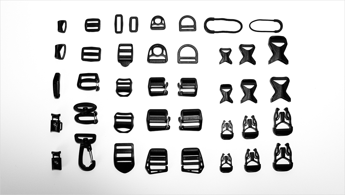 A variety of backpack straps, buckles, and strap adjusters.