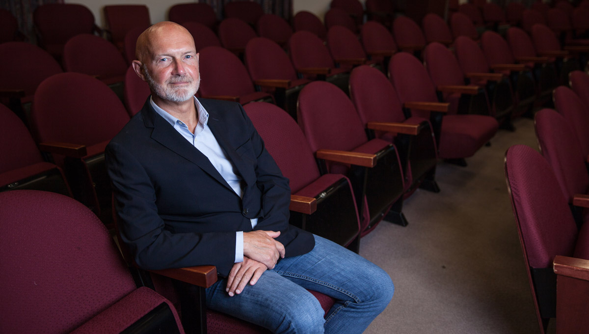 Prof. David Wood sits in a classroom theatre.