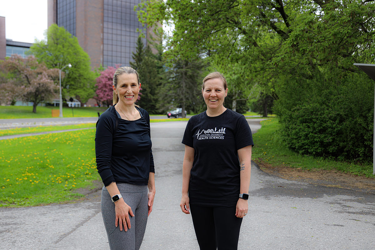 Two runners posing for a photo on a path