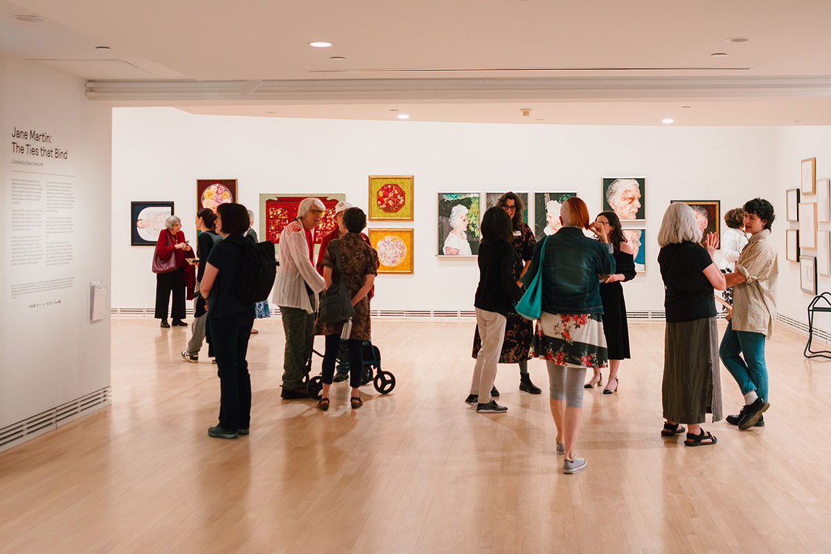 A group of people taking in the exhibits at an art gallery.