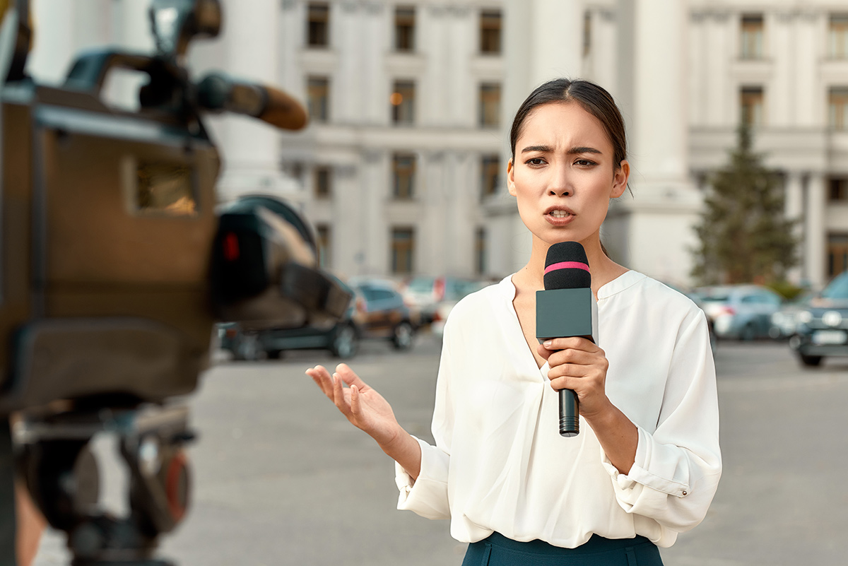 A reporter holding a microphone.