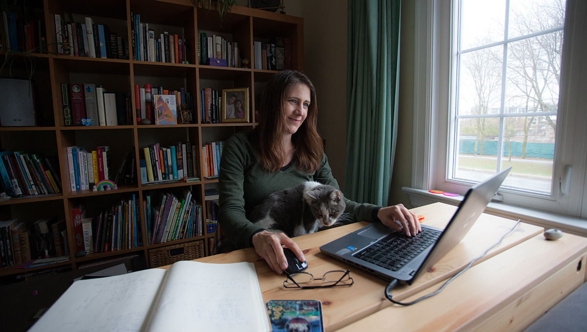 Anita Grace working on her laptop at home