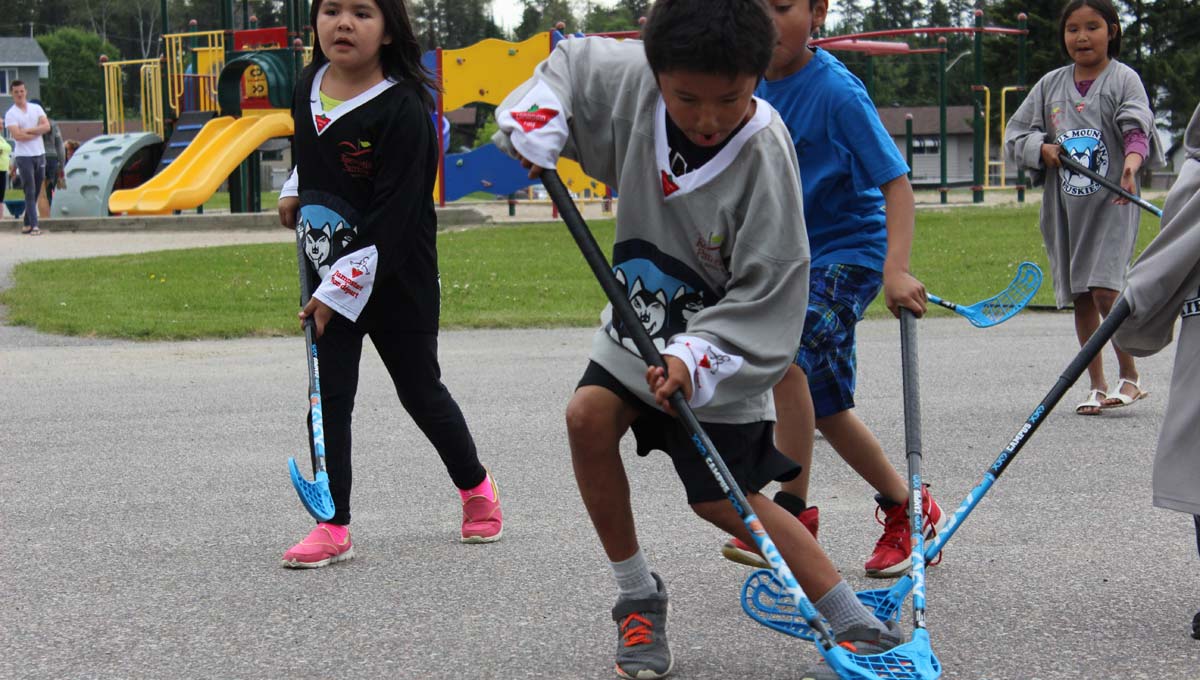 Indigenous Communities: Children and youth play sports outdoors.